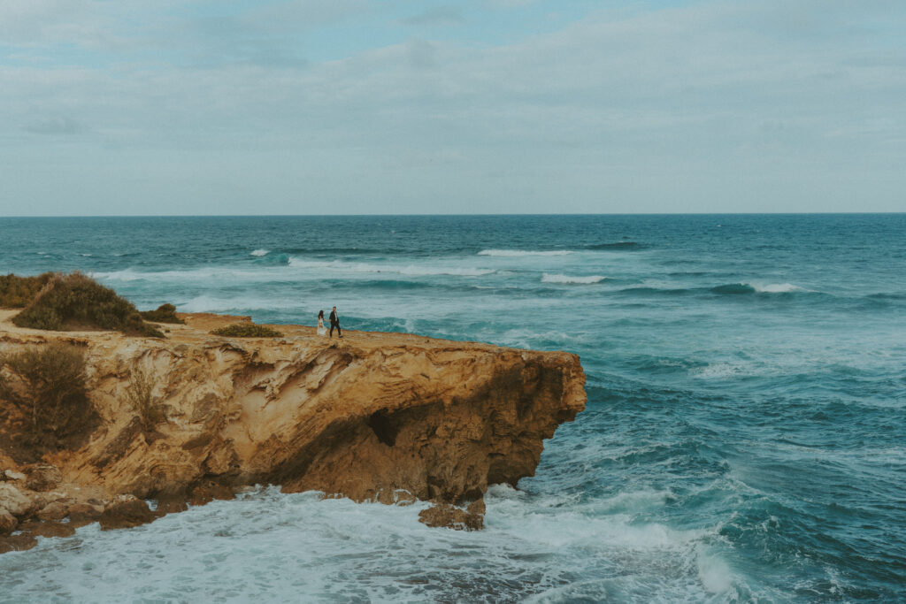 Couple exchanging vows on the cliffs during an intimate Hawaii elopement

