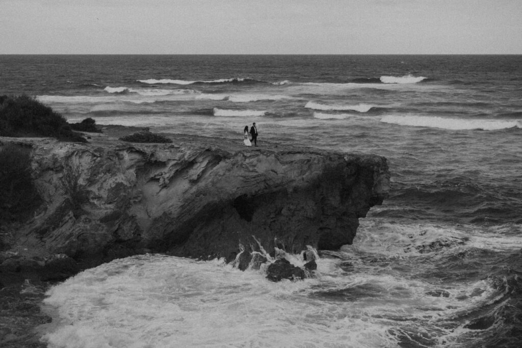 Couple exchanging vows on the cliffs during an intimate Hawaii elopement
