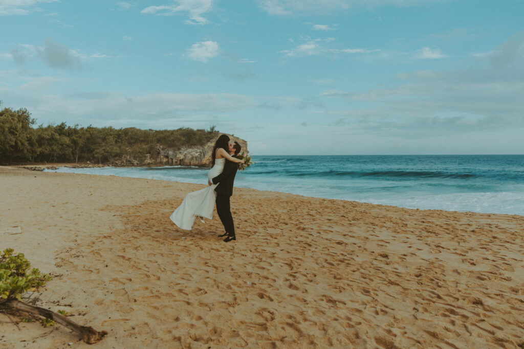 Couple exchanging vows on the cliffs during an intimate Hawaii elopement
