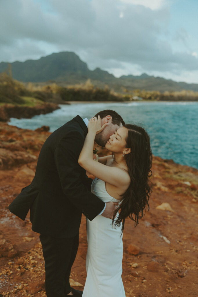 Couple exchanging vows on the cliffs during an intimate Hawaii elopement