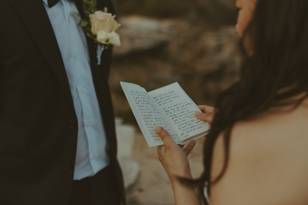 Couple exchanging vows on the cliffs during an intimate Hawaii elopement

