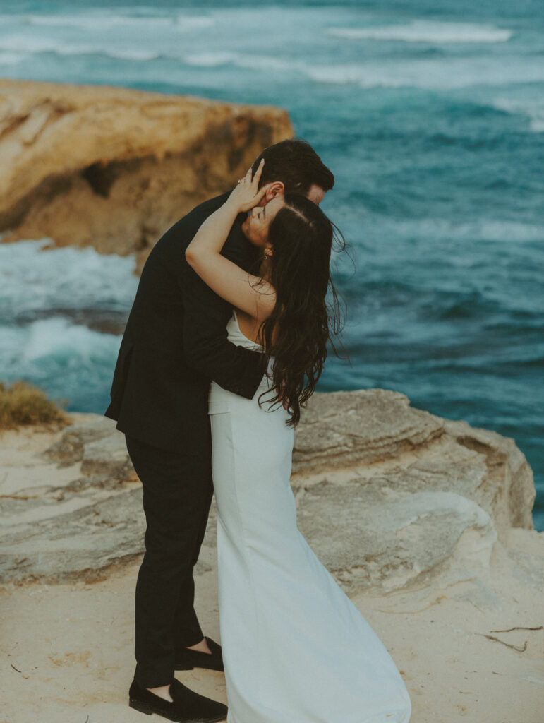 Couple exchanging vows on the cliffs during an intimate Hawaii elopement

