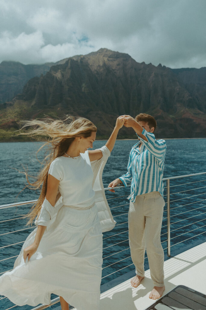 Newlyweds enjoying a honeymoon boat session off the Na Pali Coast in Kauai