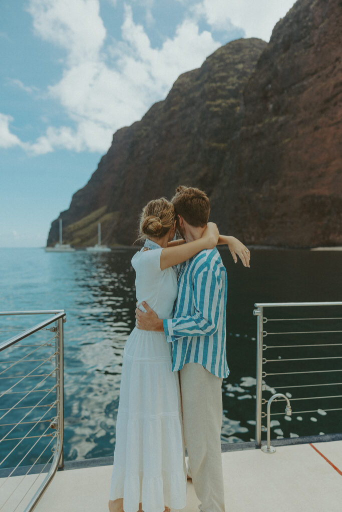 Newlyweds enjoying a honeymoon boat session off the Na Pali Coast in Kauai
