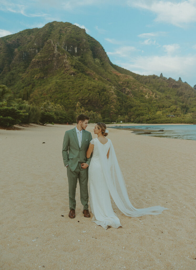 Intimate wedding ceremony at Shipwreck Beach on Kauai with ocean cliffs and soft coastal light
