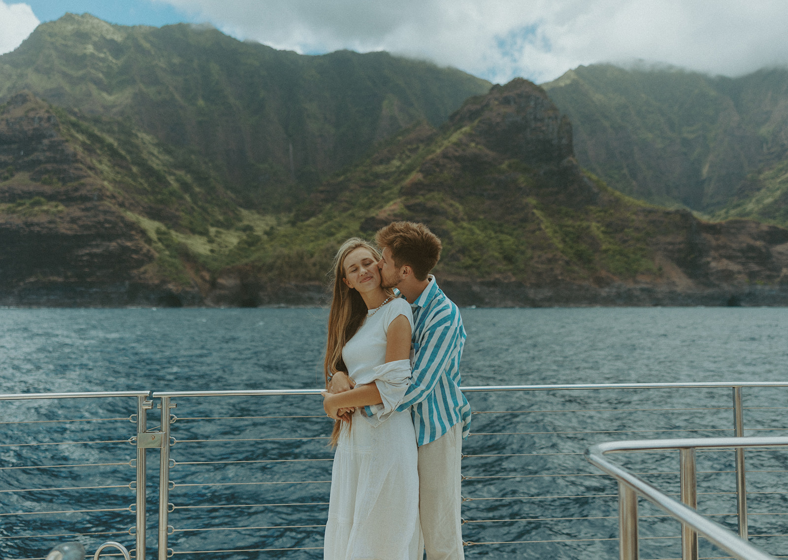 Newlyweds enjoying a honeymoon boat session off the Na Pali Coast in Kauai