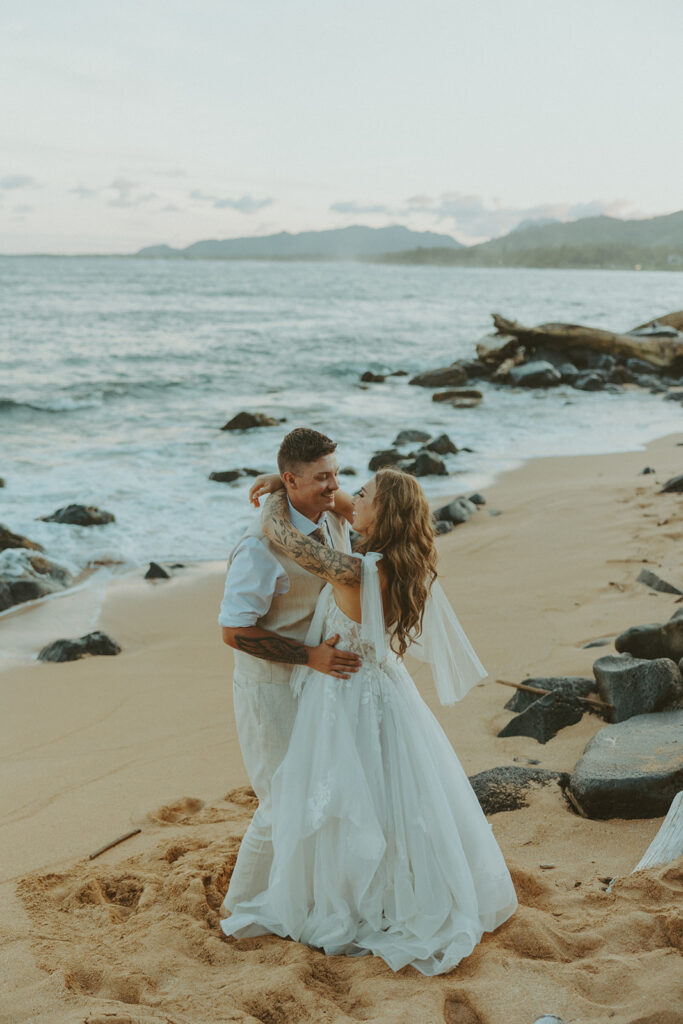 Couple sharing a quiet moment together with ocean and mountain views in Hanalei.
