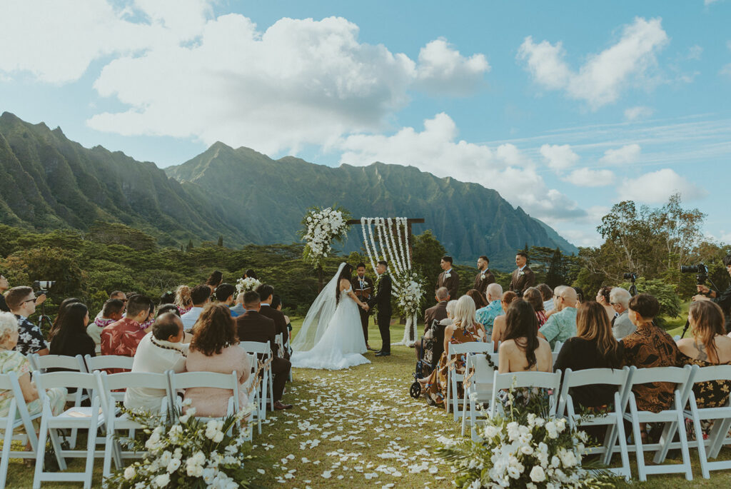 Guests seated for a scenic outdoor wedding ceremony with mountain views
