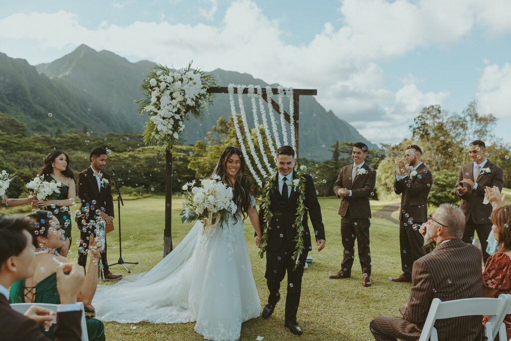 Newly married couple walking down the aisle after their ceremony