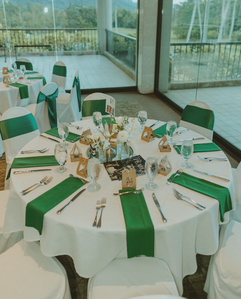 Wedding reception table decor with floral centerpieces and place settings
