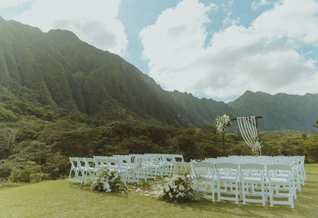Wedding ceremony aisle with floral decor and reserved seating signs