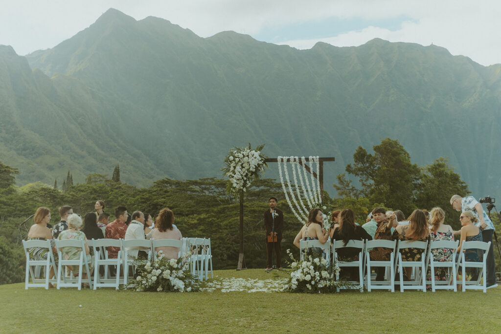 Wedding ceremony aisle with floral decor and reserved seating signs